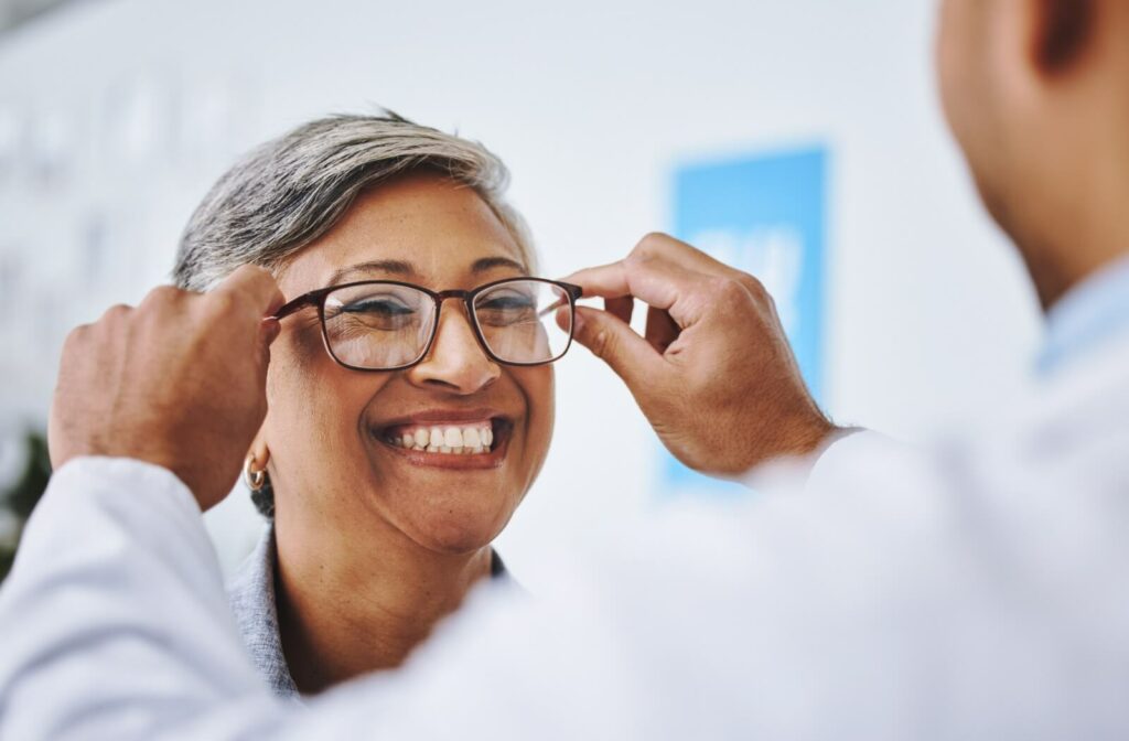 An optometrist in assisting a patient in selecting the perfect pair of eyeglasses.