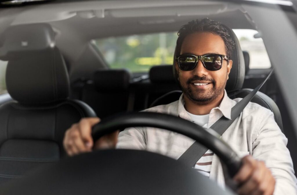 Man wearing polarized sunglasses while driving a car.